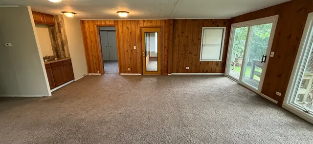 a view of hallway with furniture and large window