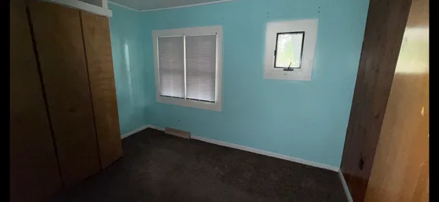 a view of an empty room with windows