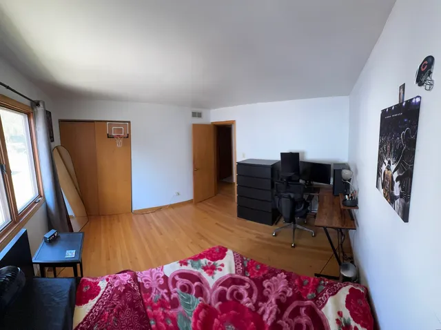 a bedroom with a bed closet and flat tv screen