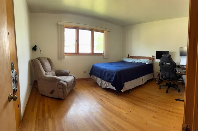 a living room with a bed furniture and a window
