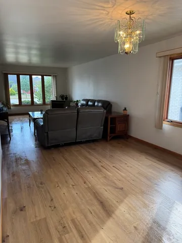 a living room with furniture and a chandelier
