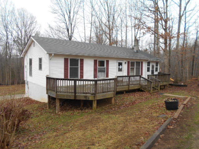 165 Village Road Shipman, VA 22971 - Photo 1 of 18 a view of a house with a wooden deck and a yard