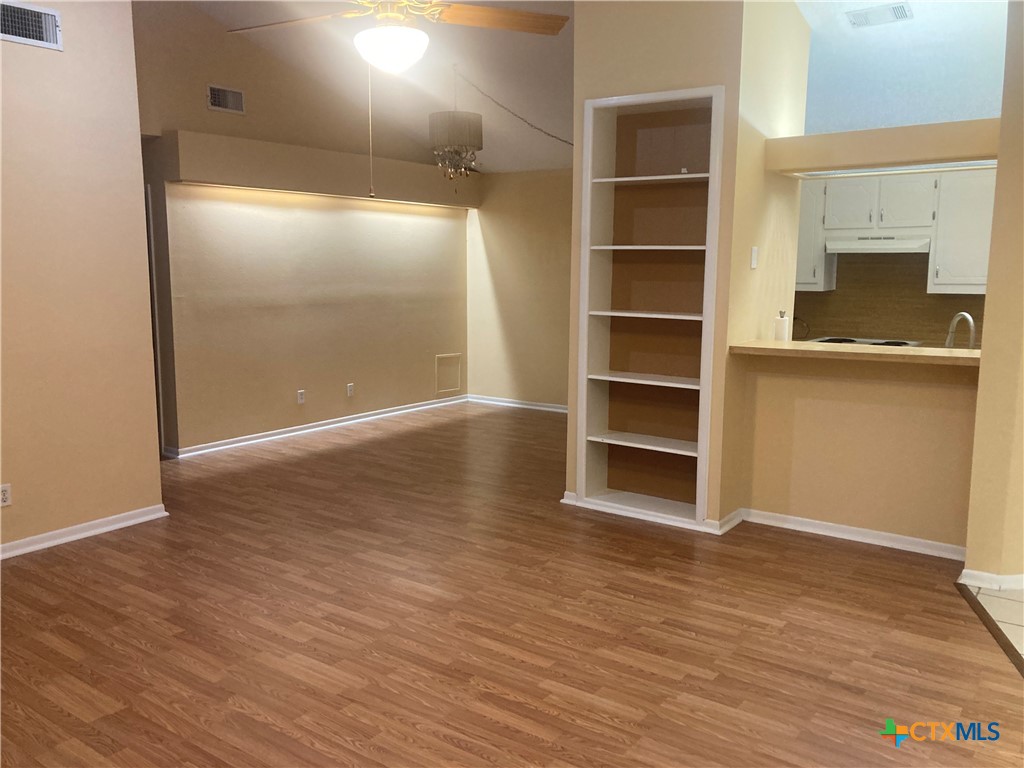 406 Rattan Drive Victoria, TX 77901 - Photo 3 of 15 a view of an empty room with a fireplace and wooden floor