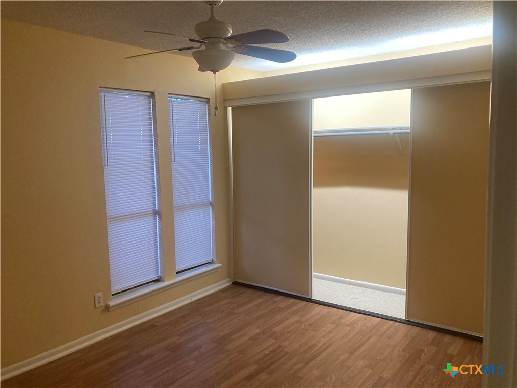 406 Rattan Drive Victoria, TX 77901 - Photo 8 of 15 an empty room with wooden floor closet and windows
