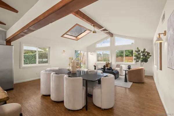 a living room with fireplace furniture and a large window