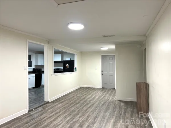 a view of empty room with wooden floor