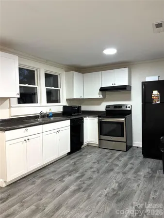a kitchen with stainless steel appliances granite countertop a stove and a sink