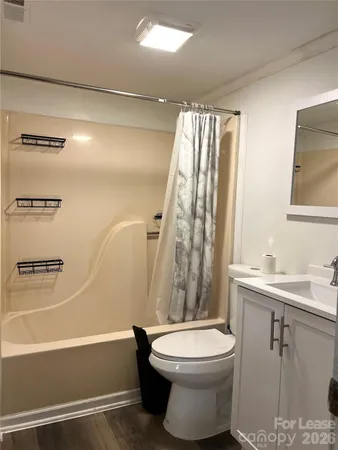 a bathroom with a toilet a sink and bathtub