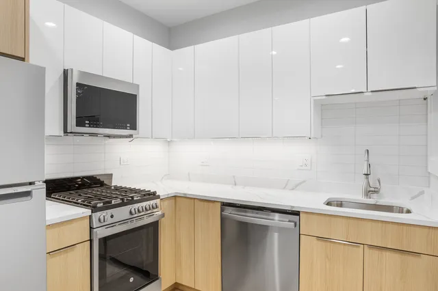 a kitchen with a sink stove and microwave
