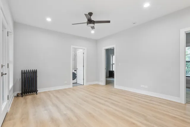 wooden floor in an empty room with a ceiling fan