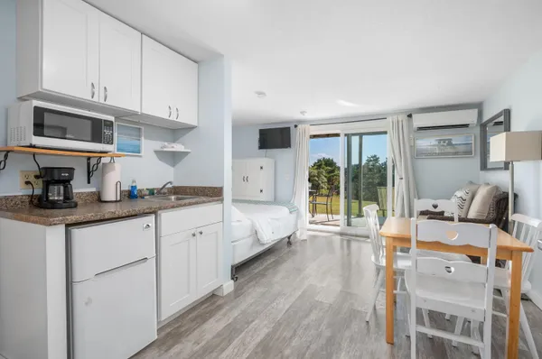 a large white kitchen with cabinets