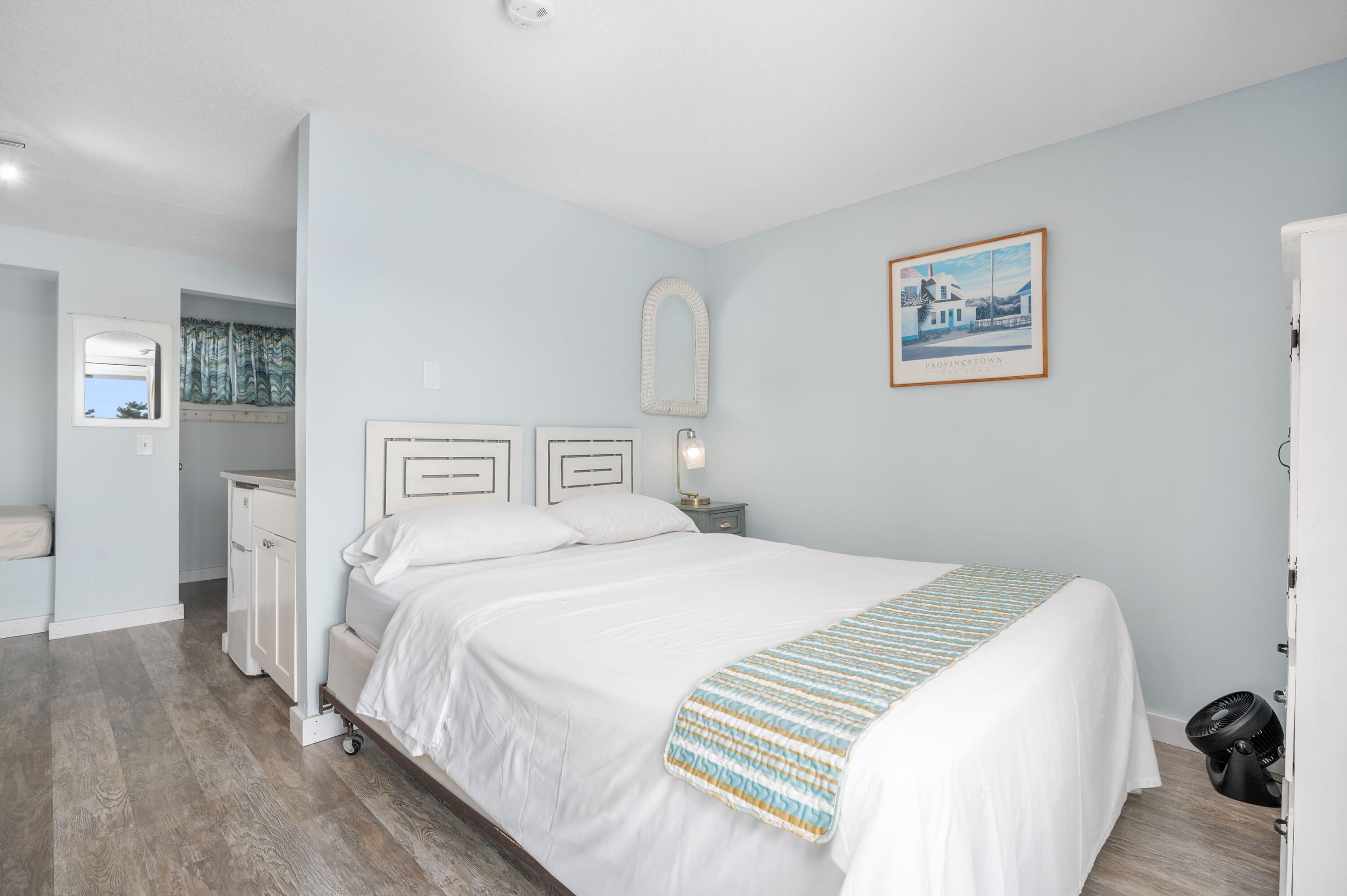 132 Shore Road, Unit 7 Truro, MA 02666 - Photo 8 of 24 a bedroom with a bed and a painting on the wall