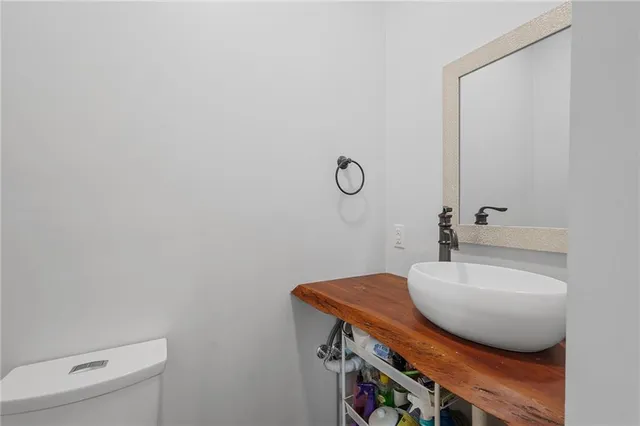 a bathroom with a sink toilet and mirror