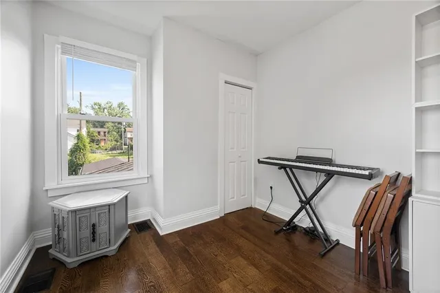 a view of a workspace with furniture and a window