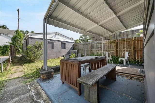 a backyard of a house with garden view and a patio