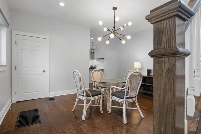 a view of a dining room with furniture and chandelier