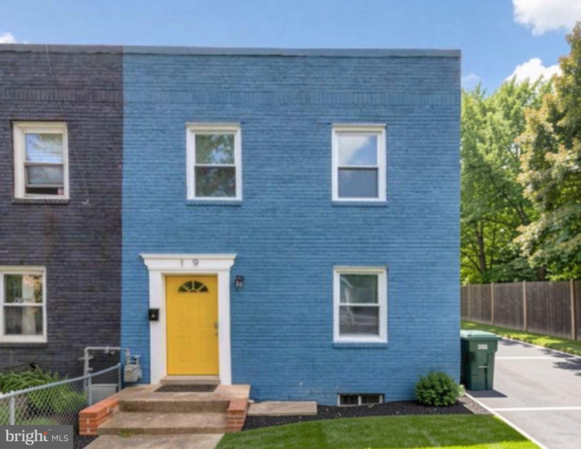 Charming two-tone home with yellow door.