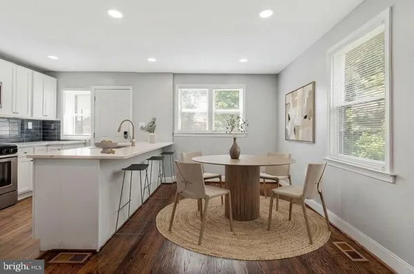 a view of a dining room with furniture window and wooden floor