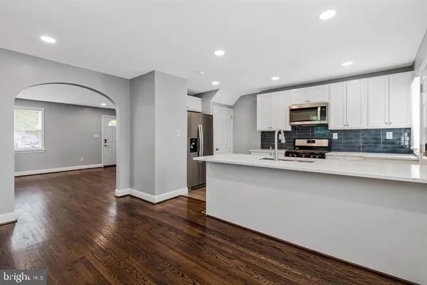 a kitchen with stainless steel appliances a refrigerator sink and microwave