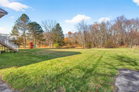 a view of a hallway with wooden floor and entryway
