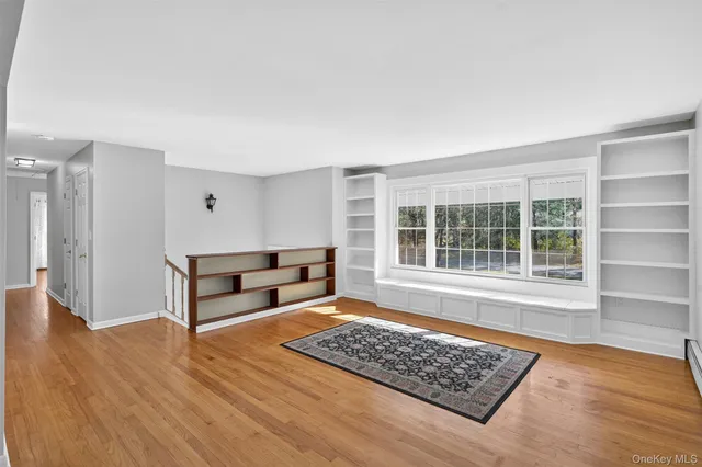 a view of a room with window and wooden floor