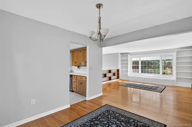 a kitchen with white cabinets stainless steel appliances and a window