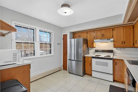 a kitchen with white cabinets and sink