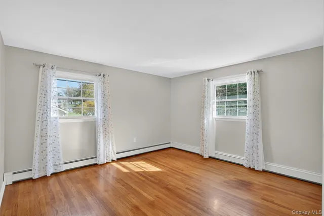 a view of entryway with wooden floor and door