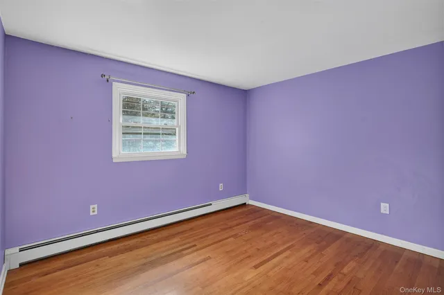 a living room with a rug and a fireplace