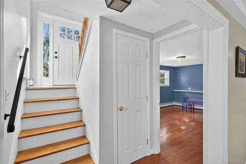 a view of a room with wooden floor and window