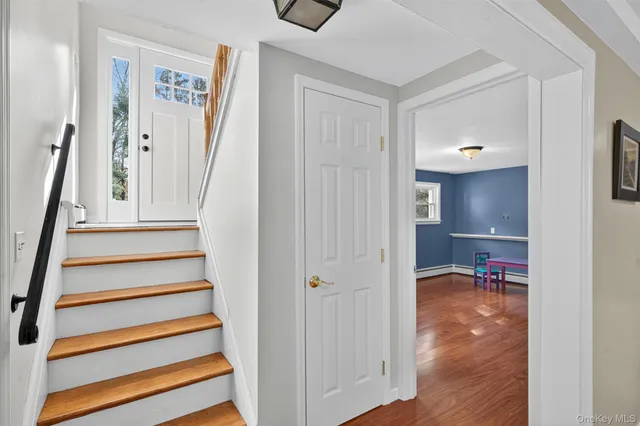 a view of a room with wooden floor and window