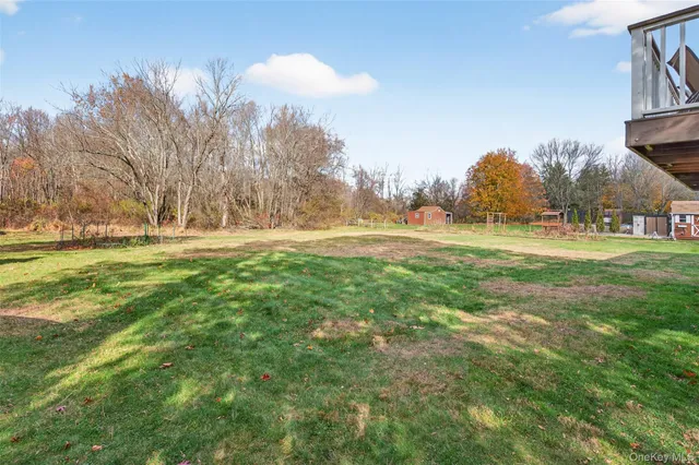 a view of a backyard with garden and patio