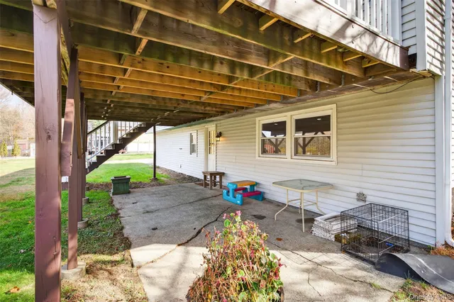 a view of balcony with deck having patio