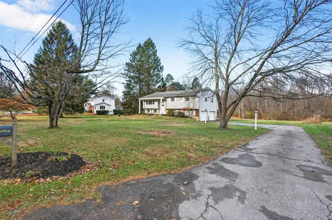 a front view of house with yard outdoor seating and green space