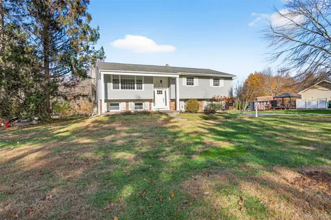 a view of backyard of house and trees