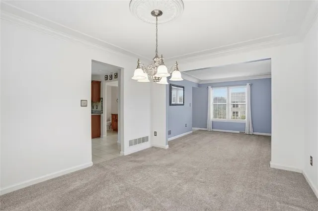 a view of a room with chandelier and windows