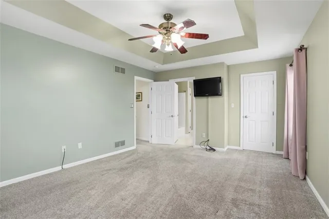 a view of an empty room with a ceiling fan
