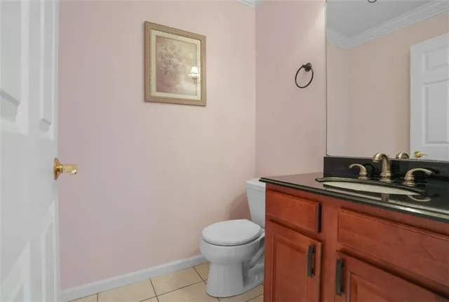 a bathroom with a toilet a sink and mirror