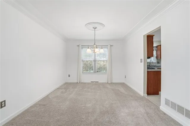 an empty room with windows and cabinet