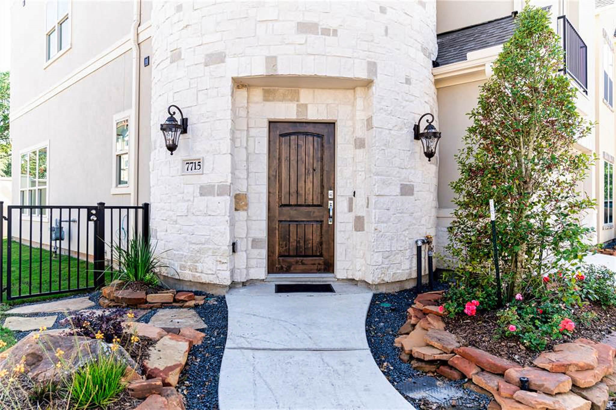 7715 South Fall Run Crossing Houston, TX 77055 - Photo 2 of 22 a front view of a house with a garden