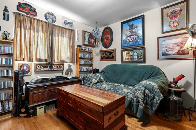 a living room with furniture and a bookshelf