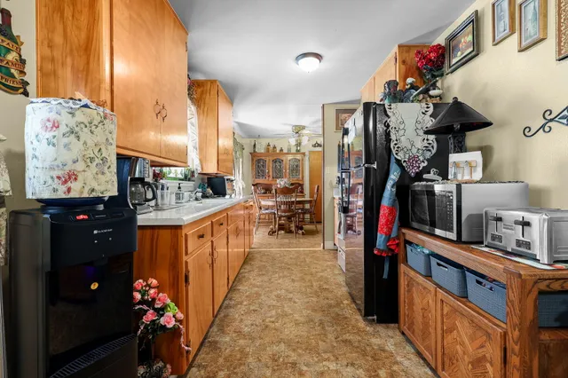 a hallway with a large kitchen stove and a refrigerator