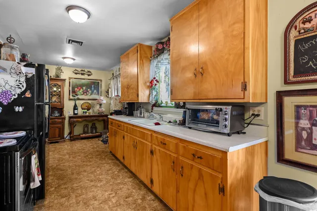 a kitchen with stainless steel appliances granite countertop a sink and cabinets