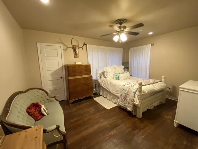 a bedroom with a bed and a chandelier