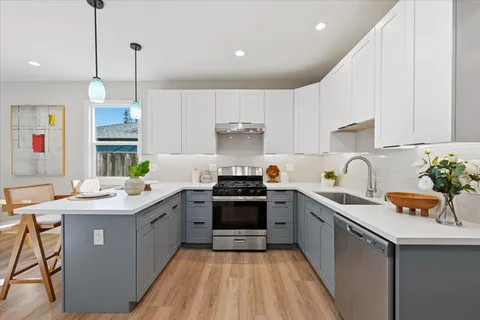 a kitchen with a sink stove and cabinets