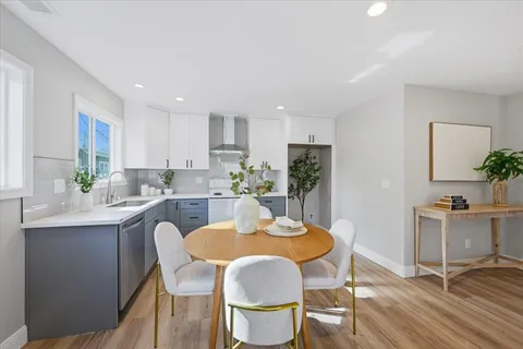 a dining room with furniture and wooden floor