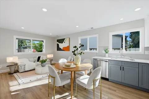 a view of a dining room with furniture and wooden floor