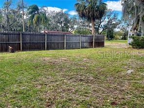 16909 Franklin Avenue, Unit B Montverde, FL 34756 - Photo 13 of 13 a view of a yard with a large tree