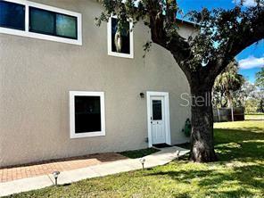 16909 Franklin Avenue, Unit B Montverde, FL 34756 - Photo 2 of 13 a house that has a tree in front of the house