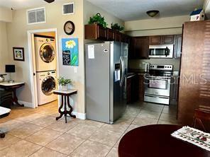 16909 Franklin Avenue, Unit B Montverde, FL 34756 - Photo 4 of 13 a kitchen with stainless steel appliances kitchen island granite countertop a refrigerator a stove and a sink